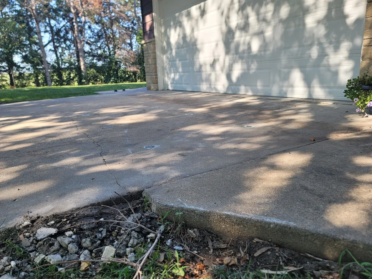 Before and after: patio slab lifted near a flower bed